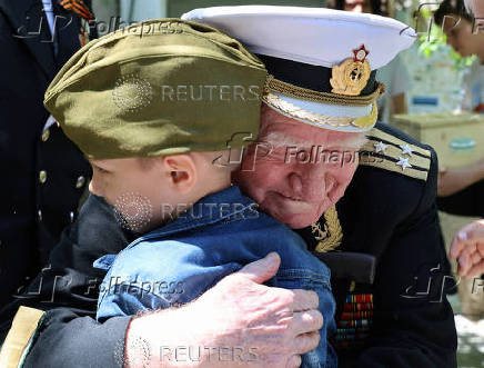 World War Two veteran Nikolai Golubtsov receives congratulations on the upcoming Victory Day in Sevastopol
