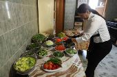 Zainab Khalifeh prepares food at her home a part of which is her restaurant called 'Zainab's table' in the town of Sarafand