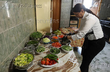 Zainab Khalifeh prepares food at her home a part of which is her restaurant called 'Zainab's table' in the town of Sarafand