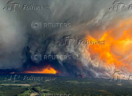 Smoke rises from the HWF040 wildfire east of the La Crete Ferry