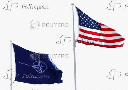 FILE PHOTO: The flags of NATO and the U.S. flutter at NATO headquarters in Brussels