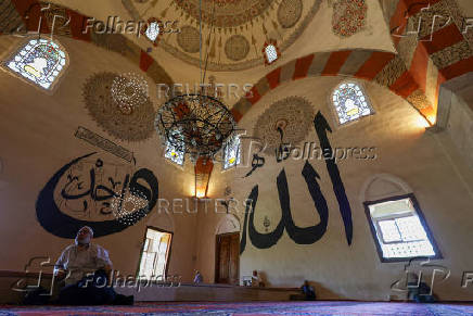 People rest before the Friday prayers at the Old Mosque in Edirne