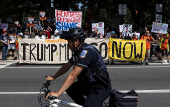Activists rally during an anti-Trump protest march to the White House in Washington