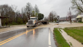 Vehicles make their way through a flooded road in Casey county, Kentucky
