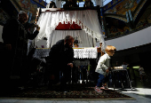 Worshippers gather for the celebrations for the Passion of the Lord at the Church of Saint Clement of Ohrid, on Good Friday, in Skopje