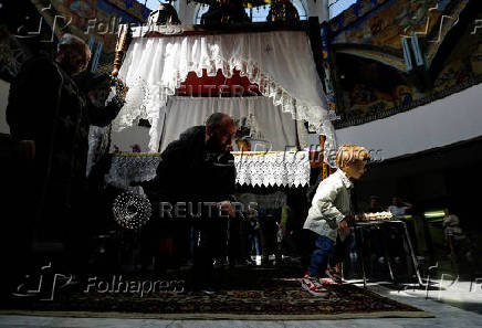 Worshippers gather for the celebrations for the Passion of the Lord at the Church of Saint Clement of Ohrid, on Good Friday, in Skopje
