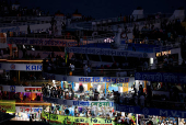 People board passenger ferries as they leave to celebrate Eid al-Adha with their families, in Dhaka