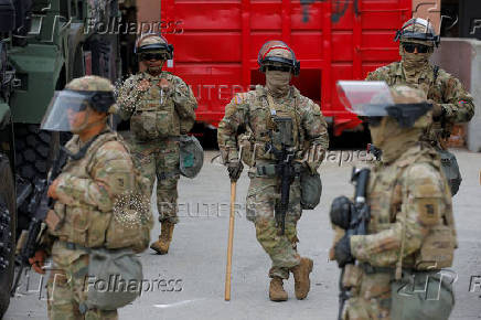 California National Guard troops stand outside the Edward R. Roybal federal building, in Los Angeles