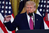 U.S. President Trump signs a resolution at the White House