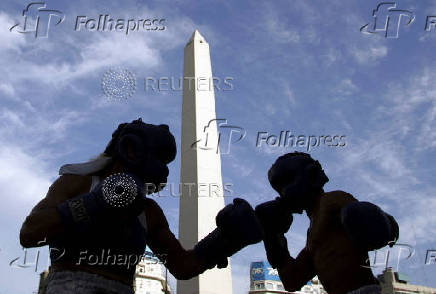 FILE PHOTO: Argentine boxers Oliveras and Ler exchange punches during a public training session in front of the obelisk in Buenos Aires