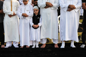 Israeli Muslims pray on the first day of the Muslim holiday of Eid al-Adha by the sea side of the Mediterranean, in Jaffa