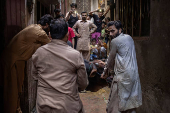 Buffalo is held ahead of sacrificial slaughter during Eid al-Adha in Lahore