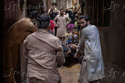 Buffalo is held ahead of sacrificial slaughter during Eid al-Adha in Lahore