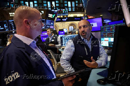 Traders work on the floor of the NYSE in New York