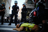 Law enforcement officers stand guard outside the U.S. immigration court at the Jacob K. Javits Federal Building during a protest against federal immigration sweeps in New York