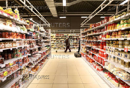 FILE PHOTO: A customer is seen inside Albert Heijn shop, operated by Ahold Delhaize, the Dutch-Belgian supermarket operator, in Eindhoven