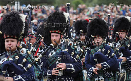 Members of a Pipe band march during the Braemar Royal Highland Gathering at the Princess Royal and Duke of Fife Memorial Park in Braemar