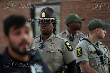 Law enforcement officers stand guard after curfew near the U.S. Customs and Immigration Enforcement facility, in Broadview