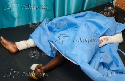 An injured woman recovers in a hospital bed following a drone strike