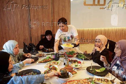 Zainab Khalifeh serves food at her home a part of which is her restaurant called 'Zainab's table' in the town of Sarafand