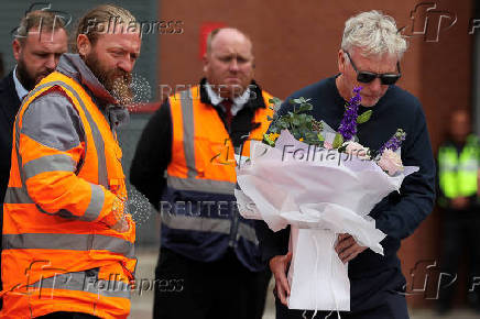 Fans pay their respects outside Anfield Stadium, on the day of the funeral of Liverpool soccer player Diogo Jota in Portugal, in Liverpool