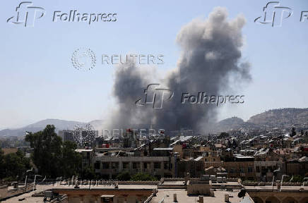 Smoke rises after strikes on Syria's defense ministry in Damascus
