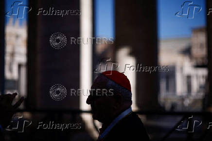 A cardinal walks in St. Peter's Square ahead of the conclave which will be held on May 7, at the Vatican