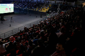Jordanians watch their national football team play against Oman on screen, as Jordan qualified for World Cup for the first time after 3-0 win over Oman, in Amman