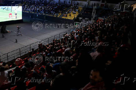 Jordanians watch their national football team play against Oman on screen, as Jordan qualified for World Cup for the first time after 3-0 win over Oman, in Amman