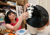 Milliner Merve Bayindir works on one of her bespoke hats ahead of the Ascot horse racing festival, in London