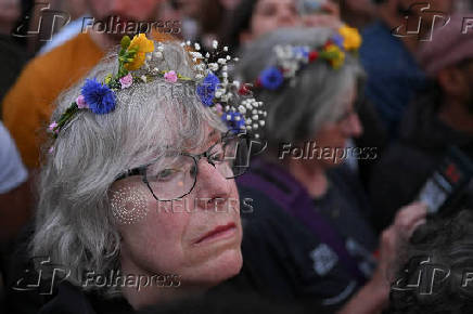 Revellers attend summer solstice celebrations during sunrise at Stonehenge near Amesbury