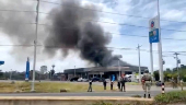 Smoke rises from a convenience store at a gas station, amid the clashes between Thailand and Cambodia, in Kantharalak district
