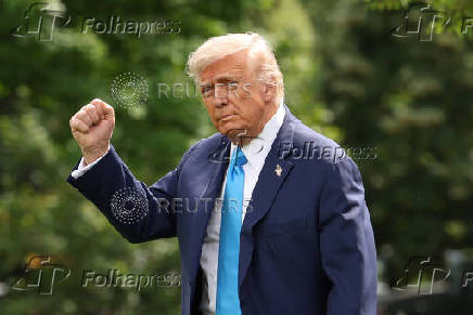 U.S. President Donald Trump speaks to reporters as he departs the White House in Washington