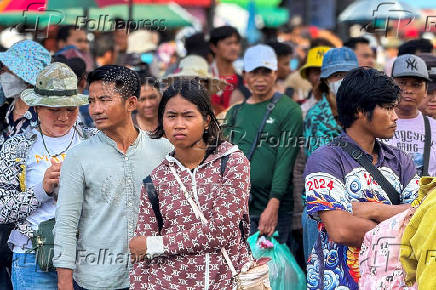 Cambodian people queue to cross the closed Khlong Luek Border Checkpoint