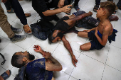Palestinians wounded by Israeli fire near an aid center, according to medics, receive treatment in Khan Younis
