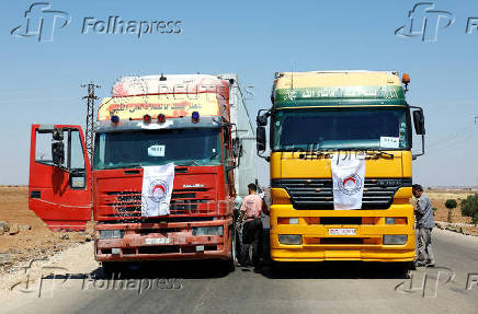 Vehicles carrying aid make their way to Sweida, at Bosra al-Sham, near Deraa