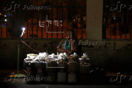 Street vendor sells dry fruits on a roadside in Karachi