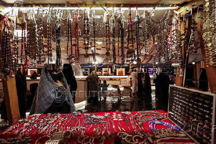 A Saudi woman looks at traditional, locally made jewellery at a Cultural and Heritage Festival in downtown Abha