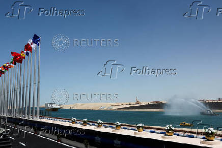 Egypt's Suez Canal Authority removes solid waste from the waters in the passage in Ismalia