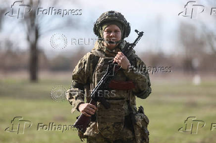 Young recruit of the Ukrainian Armed Forces poses for a picture in Kyiv region