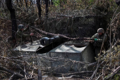 Servicemen of the Ukrainian Armed Forces fire a self-propelled howitzer towards Russian troops at a front line in Donetsk region
