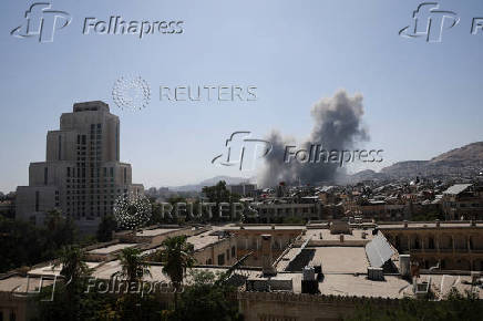Smoke rises after strikes on Syria's defense ministry in Damascus