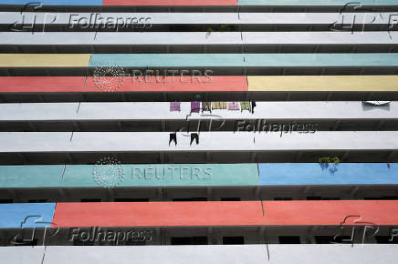 Residents hang their laundry to dry along the corridor of a public housing estate in Singapore