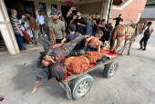 Casualties are transported after Palestinians were wounded by Israeli fire near an aid center, according to medics, in Khan Younis