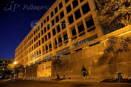 FILE PHOTO: A person walks by the Department of Labor headquarters in Washington, D.C.