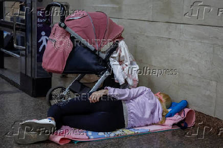 People take shelter inside a metro station during an air raid alert in Kyiv