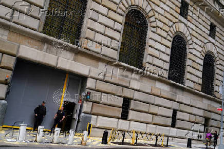 FILE PHOTO: Security guards stand outside of the Federal Reserve Bank of New York in the Manhattan borough of New York City