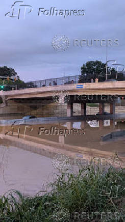 Vehicles stand on a flooded road, in Chattanooga