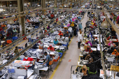 Bangladeshi garment workers sew at a textile factory in Gazipur