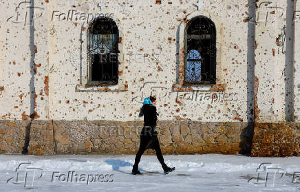 FILE PHOTO: A woman walks outside St. Iveron Convent in Donetsk